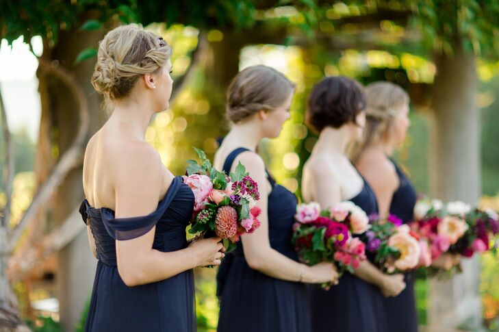 Bridesmaids in Navy Dresses Holding Bright Bouquets