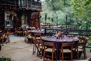 Round Tables with Purple Tablecloths and Wooden Chairs