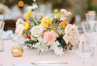summer wedding centerpiece with yellow and blush roses
