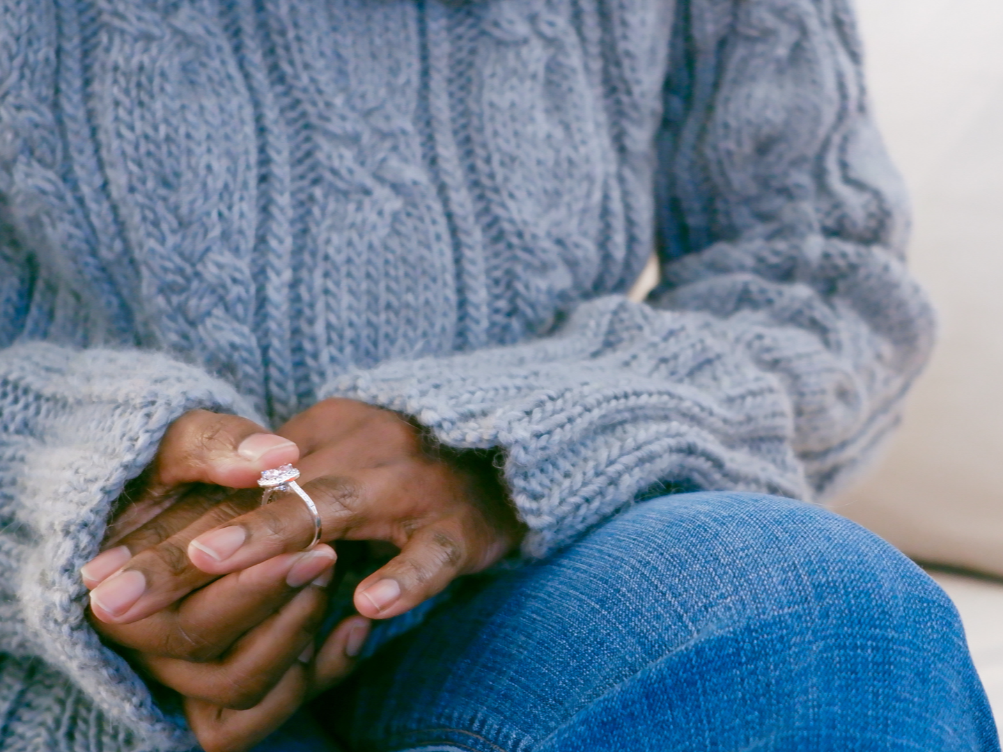 woman anxiously holding engagement ring