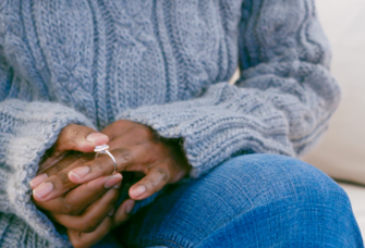 woman anxiously holding engagement ring