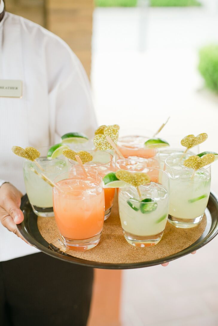 The newlyweds served up colorful his and hers signature drinks during cocktail hour - a Greyhound and a Jalapeno Margarita. A glittery gold heart stirrer was placed in each drink for a fun touch.