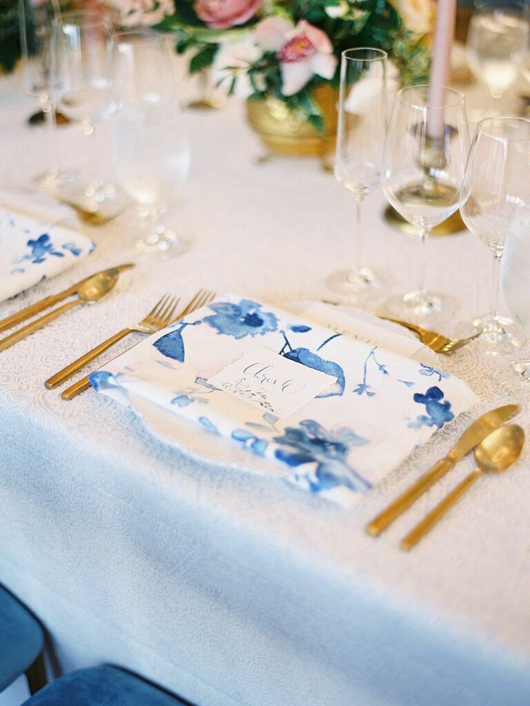 wedding place setting with blue and white floral patterned cloth napkin
