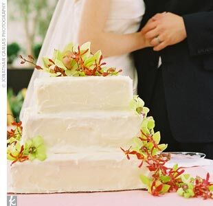 Keeping with their simple yet chic style, Colby and Roger's wedding cake was a square three-tier lemon delight with cream cheese frosting, decorated with a cascade of lime green orchids.