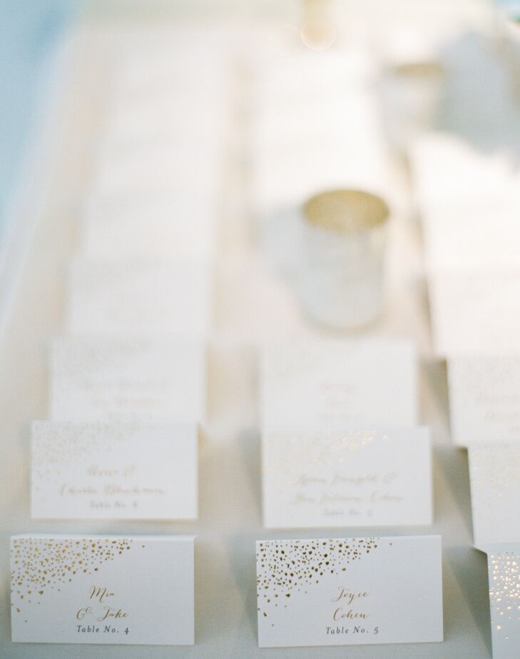 Mia and Jake wove the gold-splatter motif from their invitations into the day-of stationery elements, including the escort cards. Guests' names were written in gold-foil script and accompanied by playful gold confetti for a festive feel.