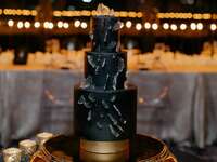 Three-tier black wedding cake. 