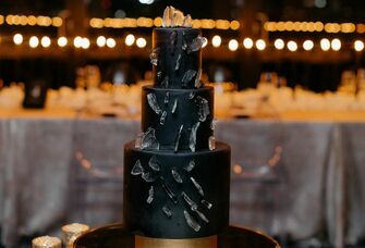 Three-tier black wedding cake. 
