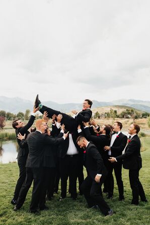 Groomsmen Throwing Groom in Air During Portraits