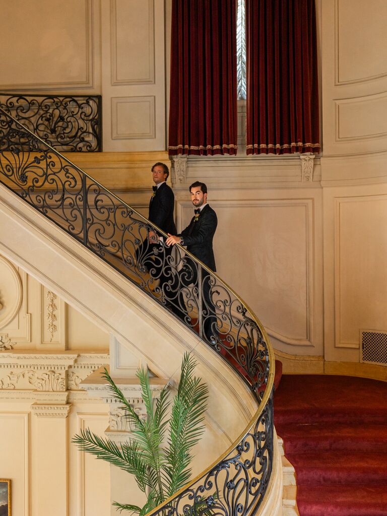 Whitaker Irvin and Michael Mendieta walking up stars inside Rosecliff Mansion