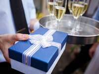 wrapped present near champagne glasses