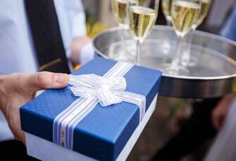 wrapped present near champagne glasses