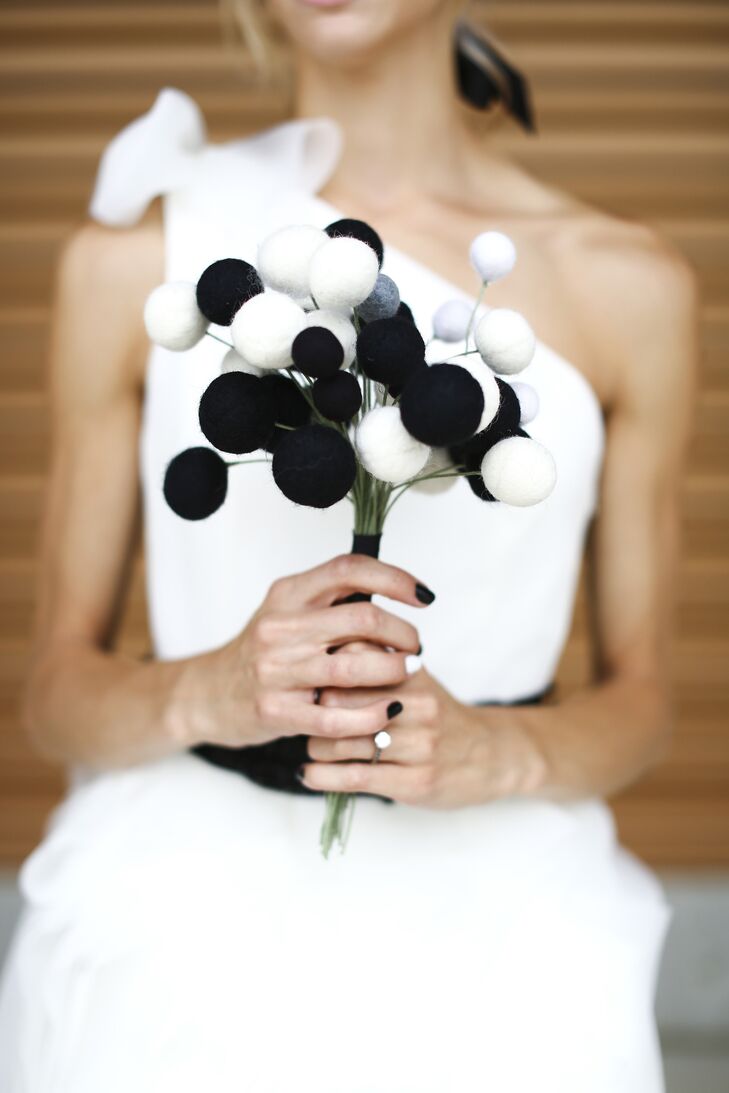 Punchy felt pom poms in black and white made up Alexa's modern bridal bouquet.