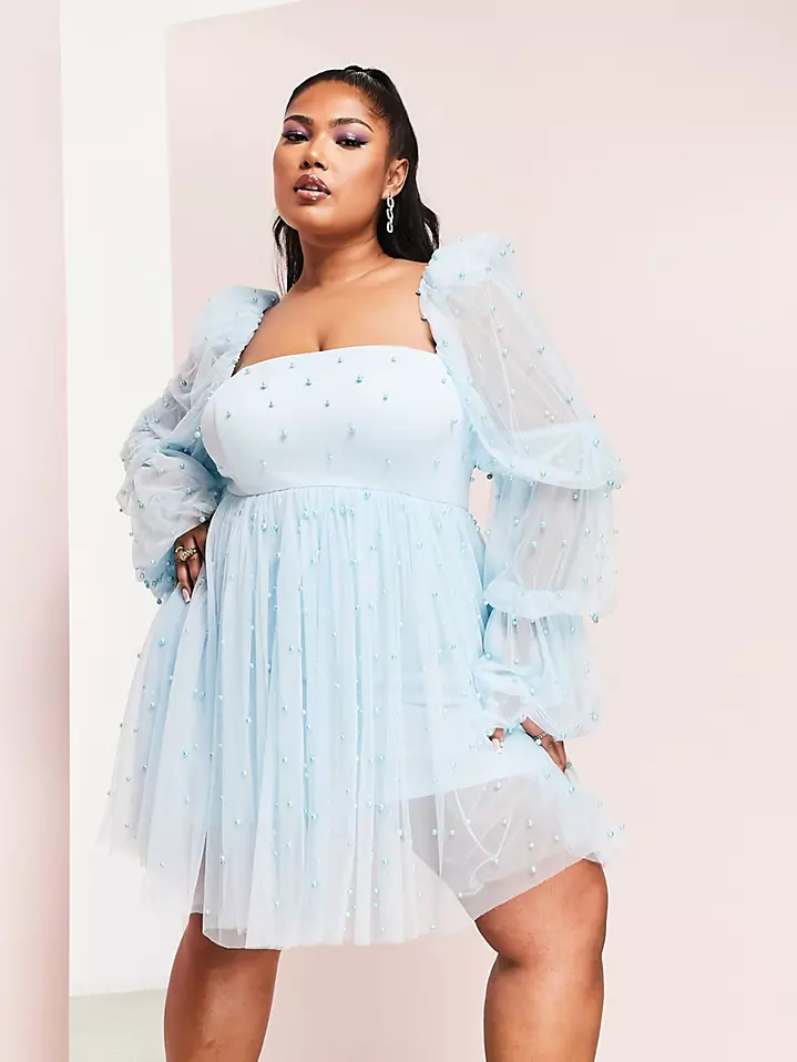 A model shows off this gorgeous pale blue gown with sheer princess sleeves.