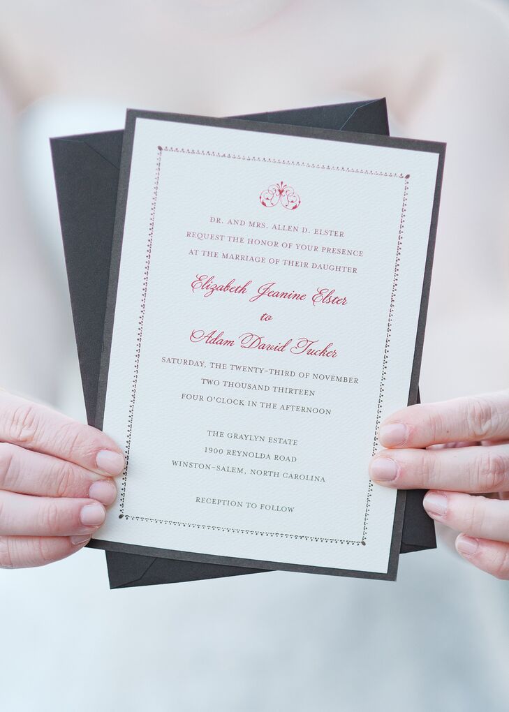 Traditional invitations with a dark red script and an elegant border set the tone for the wedding's elegant, formal theme.