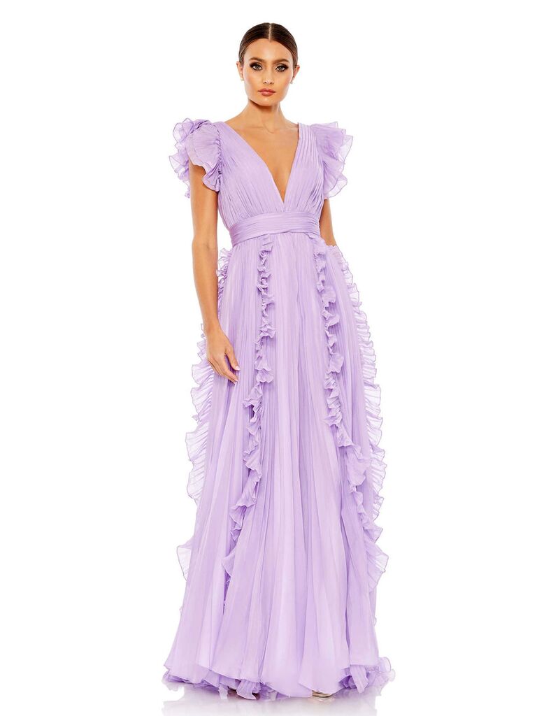 Model wears a ruffled purple gown. 