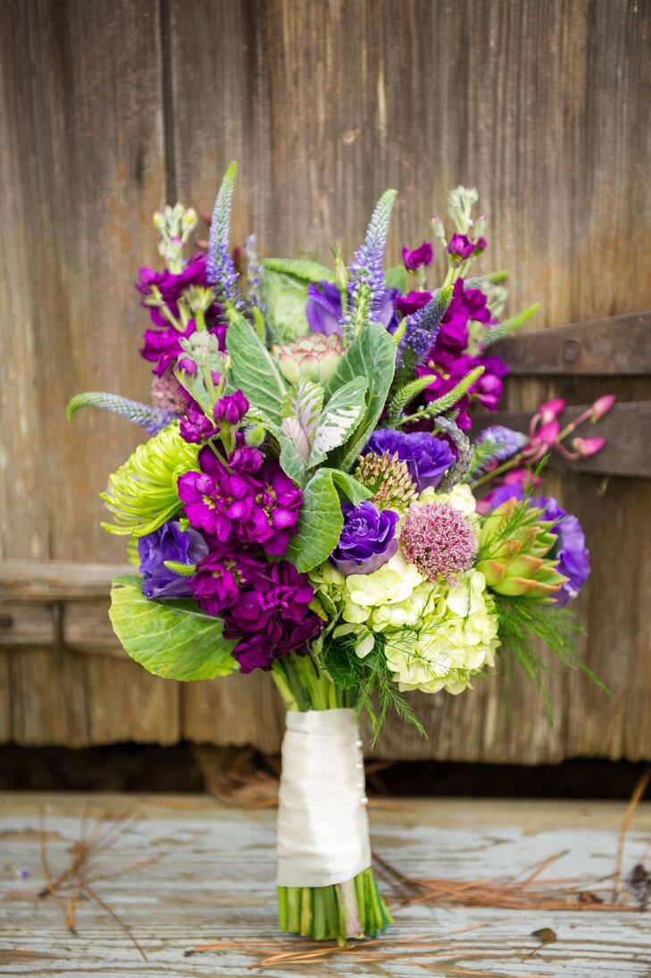 The bride carried a bouquet of purple flowers down the aisle, including veronica, stock flowers, hydrangeas and scabiosas.