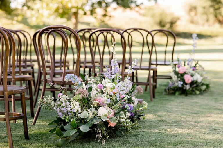 Pastel-hued floral aisle arrangements