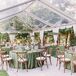 Woodland-Themed Tented Wedding Reception With Green Linens and Cross-Back Chairs