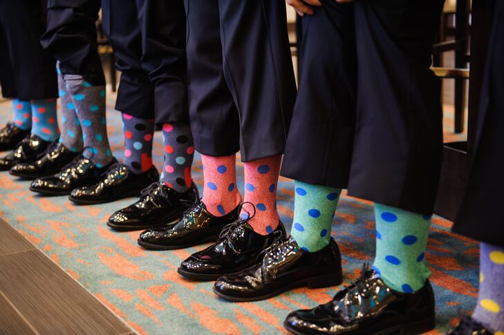 The groomsmen wore colorful polka dot socks, adding a touch of whimsy to their style.