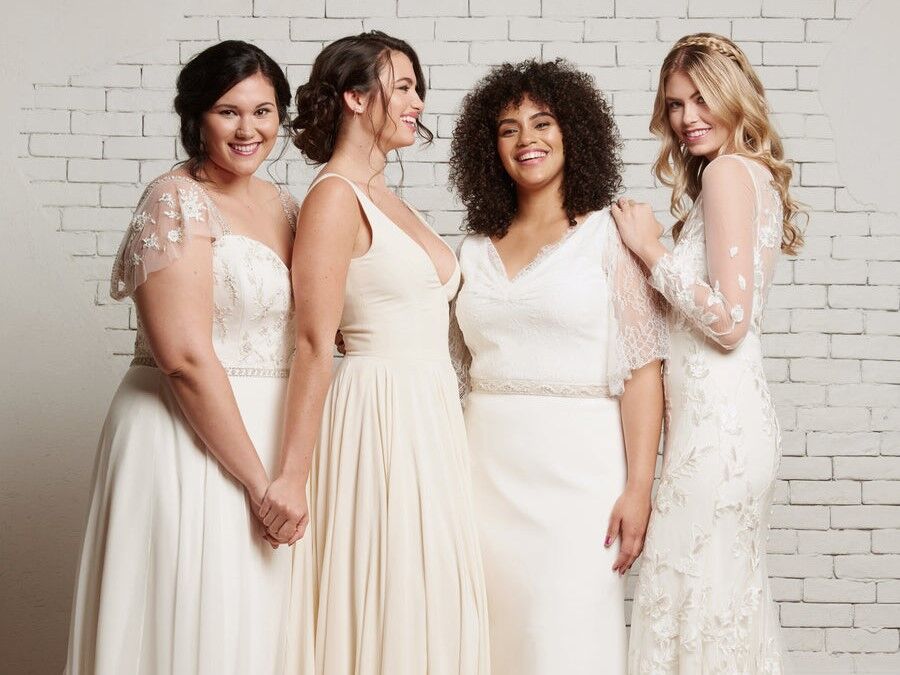 group of women wearing Rebecca Schoneveld wedding dresses. 