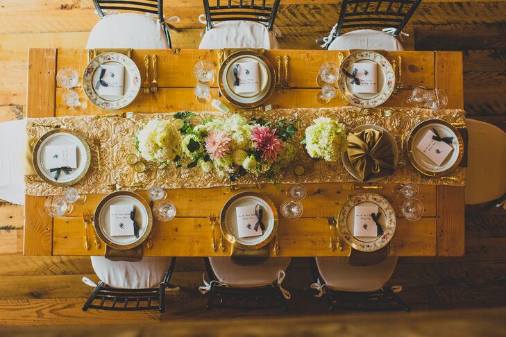 Farmhouse dining tables at the reception were set with gold table runners and black chiavari chairs.