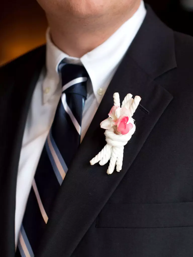 White knotted boutonnière as a tie the knot idea.