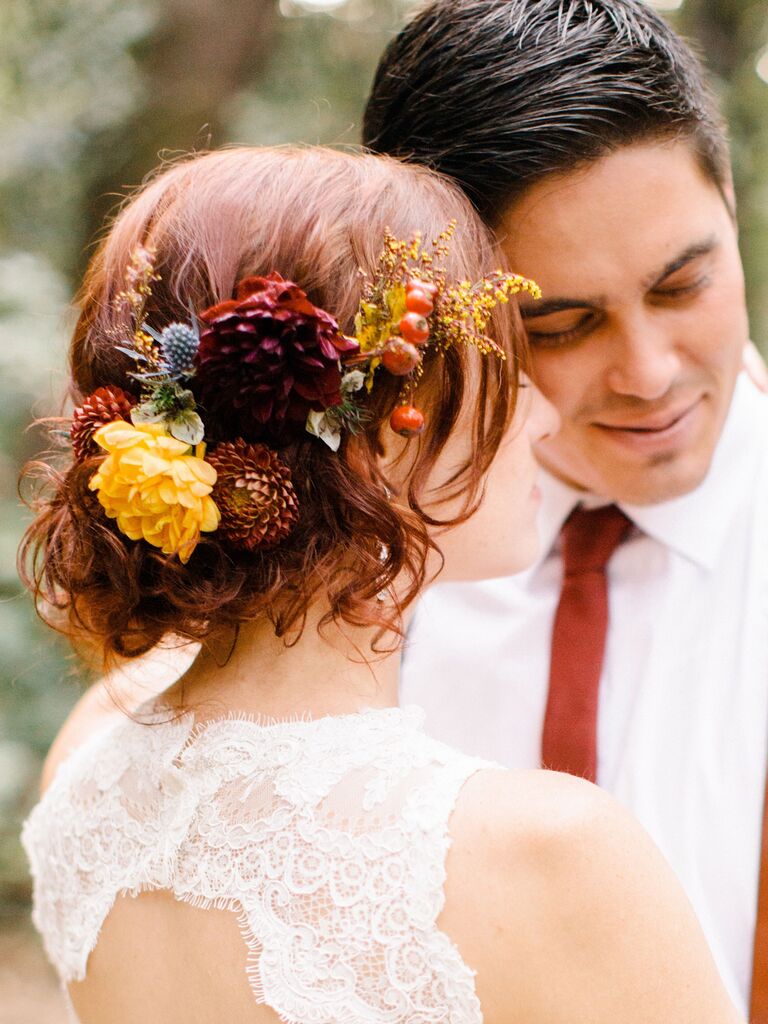 wedding hair flowers moody florals above low bun