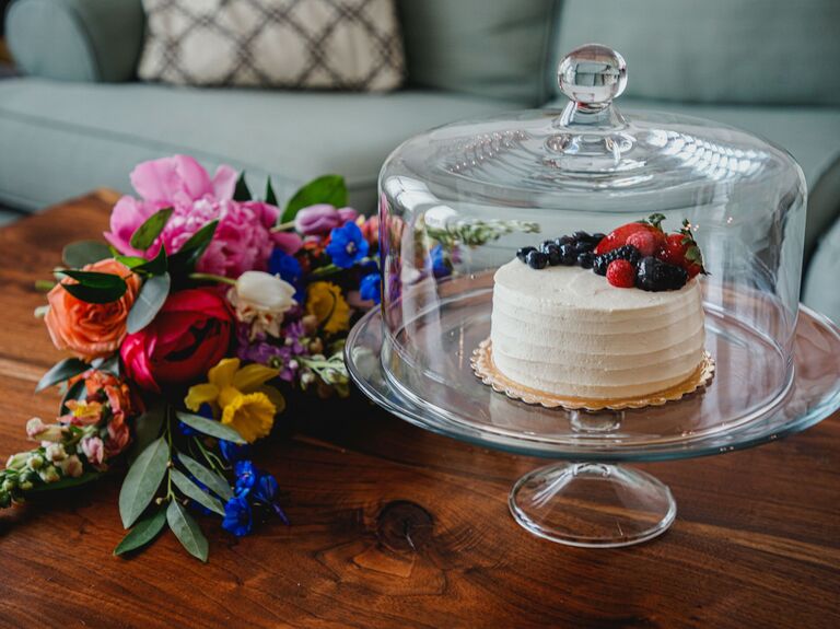 single tier wedding cake in glass cloche