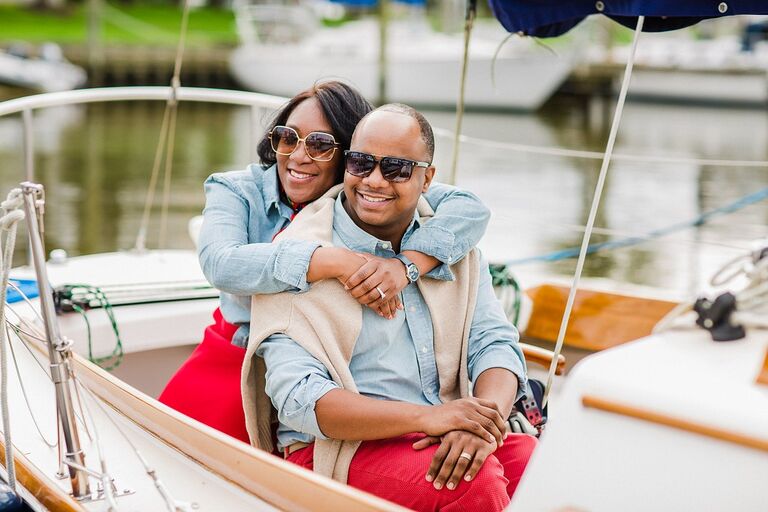 Couple shares hug during nautical boat engagement photo shoot