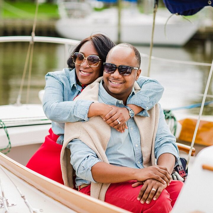 Couple shares hug during nautical boat engagement photo shoot