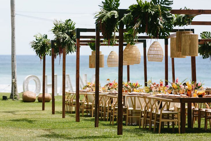 Reception Tables on Lawn Under Arches With Hanging Tropical Decor, Waterfront