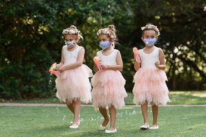Flower Girls Walking Down the Aisle With Bubble Makers