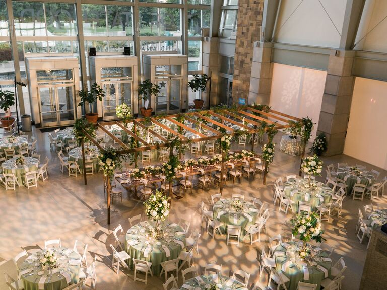 museum wedding reception venue with decorative spotlights and wooden pergola above the head table