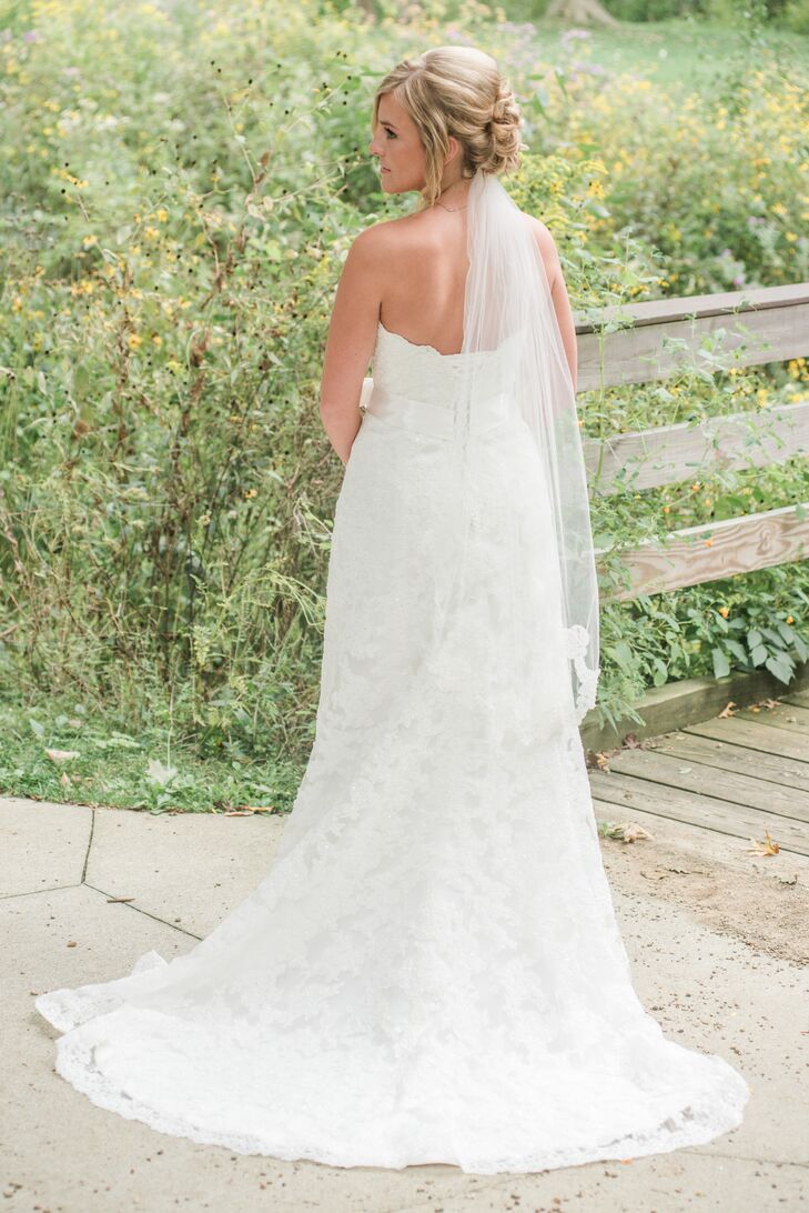Ashley wore an ivory wedding dress with long train in the back. She wore a classic ivory veil.