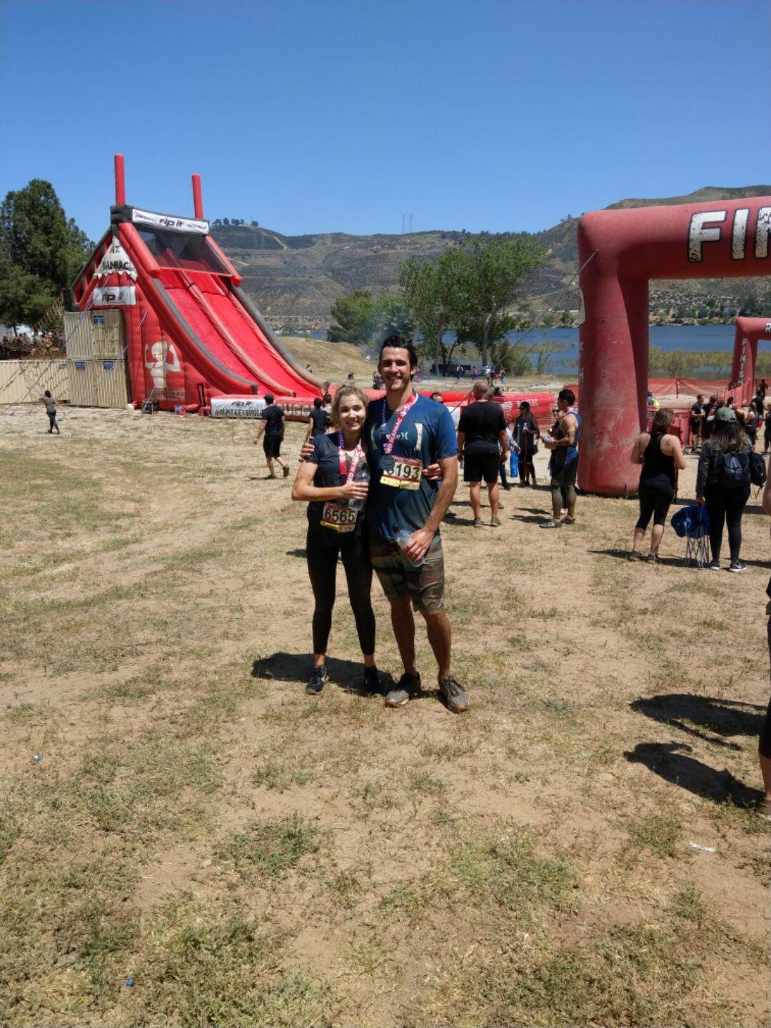 2 Rugged Maniacs make it through a mud course.