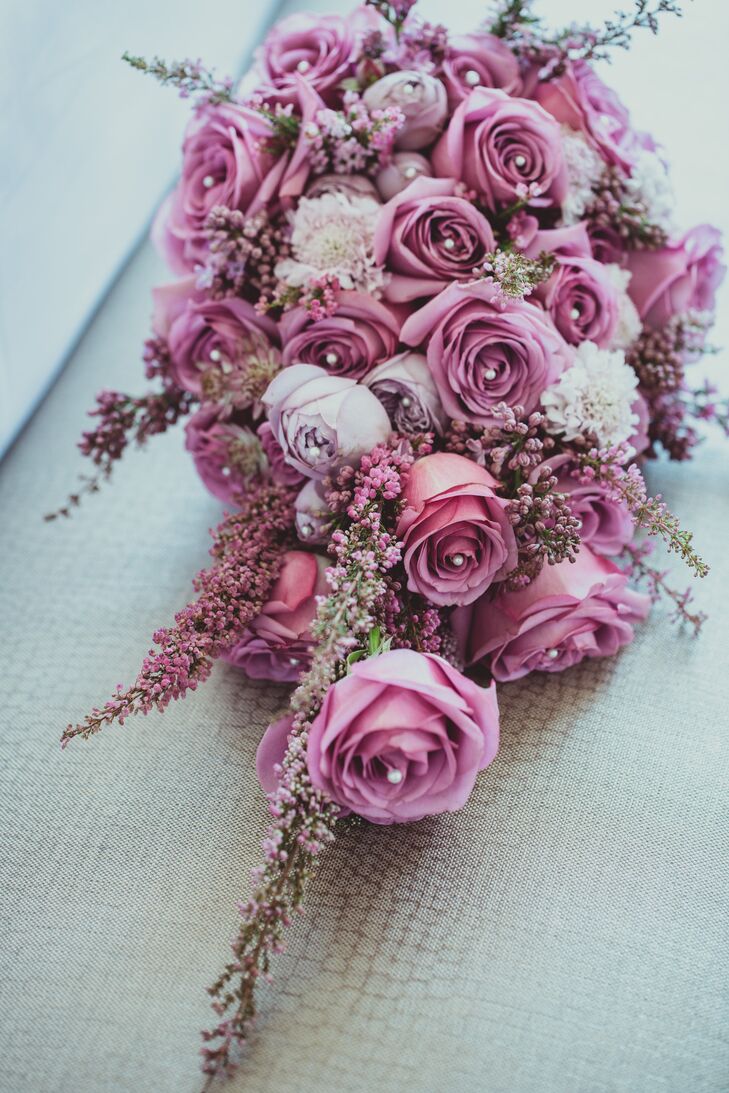 Dongli held a bouquet of roses with beaded centers accented with veronica, in different hues of purple that embodied a beautiful blend of the main color used at the wedding.