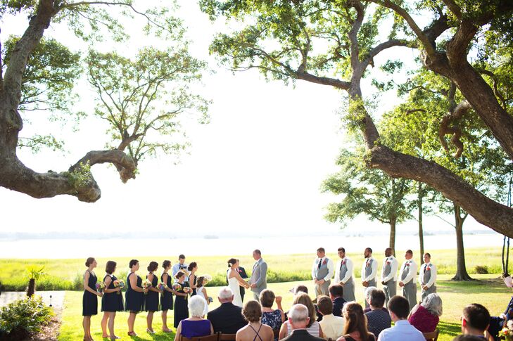 The couple exchanged vows under a canopy of live oaks overlooking the Ashley River, followed by a cocktail hour on the main house's balcony.
