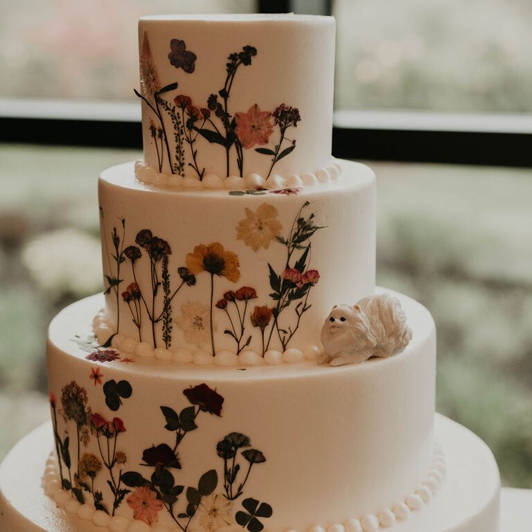 Tiered white wedding cake with wildflower designs