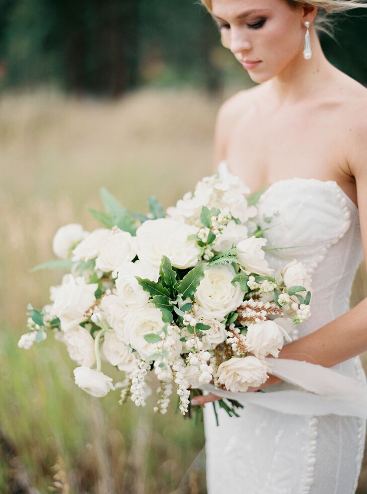 Morgan's bouquet consisted of cream hydrangeas, ivory garden roses and greenery. The bouquet had a long, flowing hand-dyed ribbon wrapped around the base, from Tono & Co.