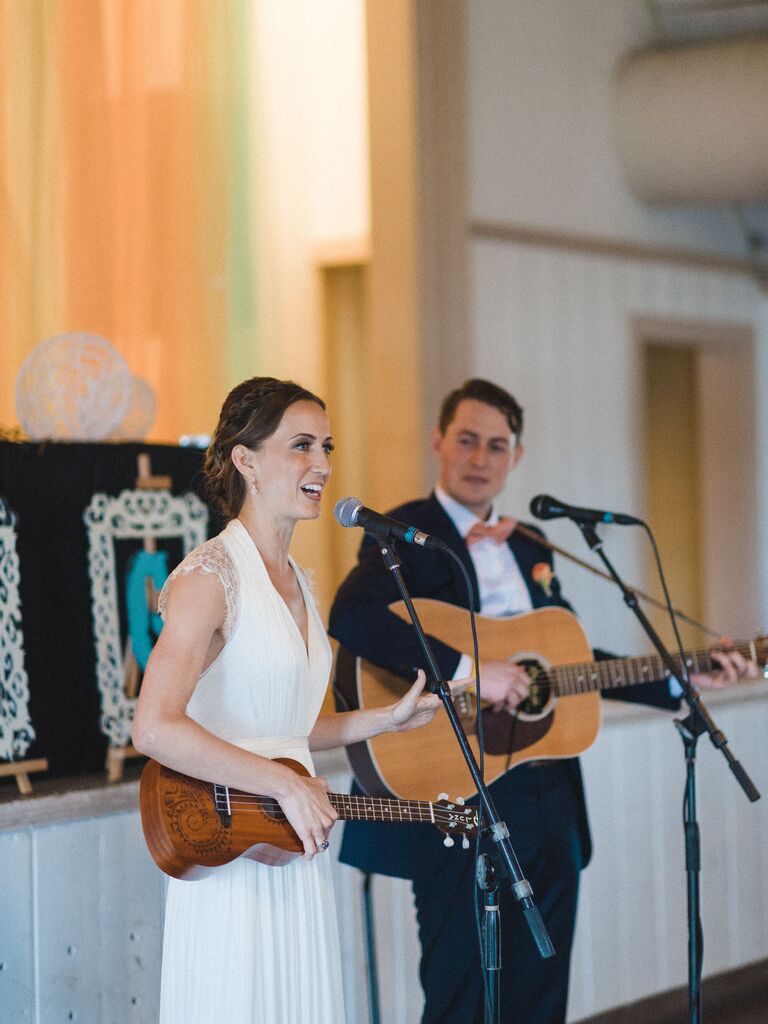 Bride and groom playing music at wedding. 
