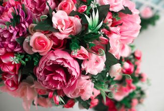 A spring-time bouquet of pink and fuchsia artificial flowers.