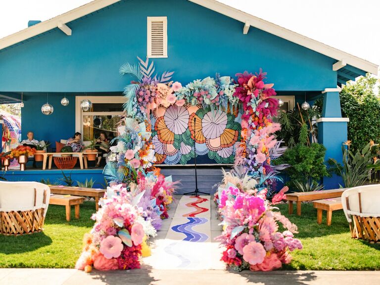 Colorful aisle runner featuring bright flowers and feathers. 