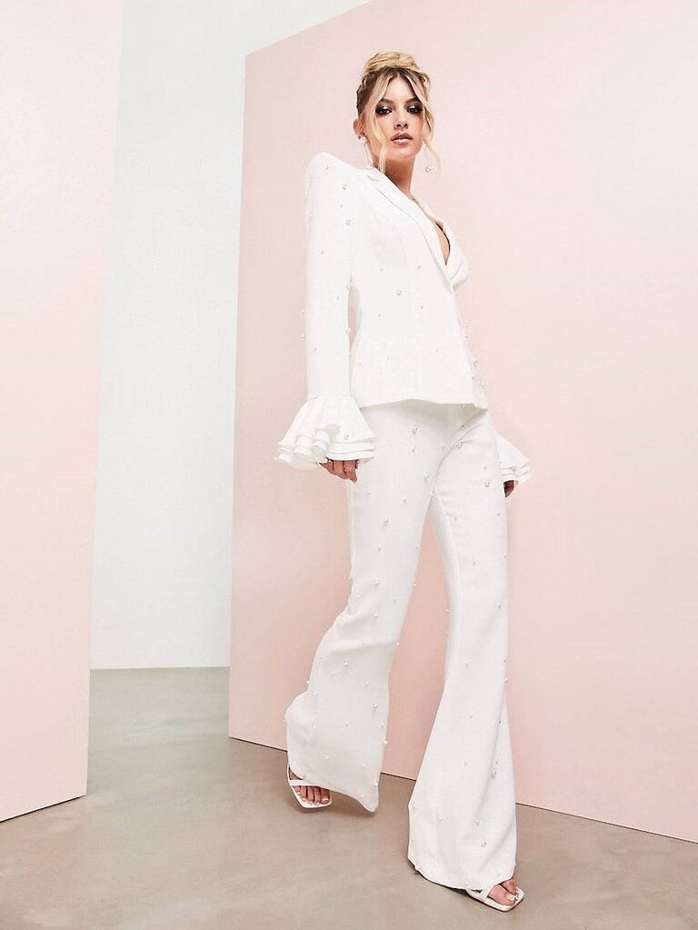 White pant suit with flared hems.
