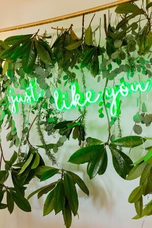 Neon Green Sign Above Wedding Reception Sweetheart Table, Cursive, "Just Like You" With Greenery