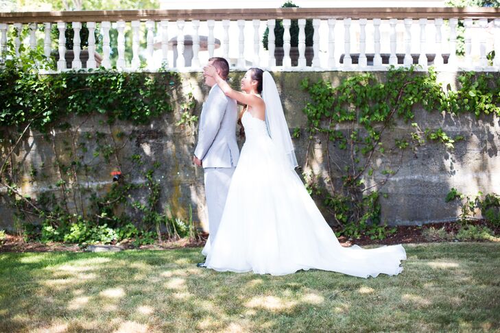 Denise walked up behind James so they could see each other for the first time in their wedding day attire. As she did so, the long train of her white wedding dress trailed elegantly behind.