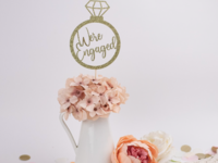 'We're engaged' glittery gold ring shaped engagement party center piece