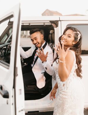 Bride and Groom Showing Off Wedding Rings in Jeep Getaway Car