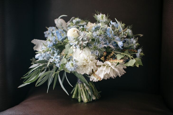 Amy Young of Leaves of Grass Floral Design put her floral design skills to work, creating eye-catching arrangements with a distinct organic vibe. For Samantha’s bouquet, she put together a beautiful mix of white dahlias, blue delphiniums, dusty miller, eucalyptus and more, which perfectly embodied the day’s palette and feel.