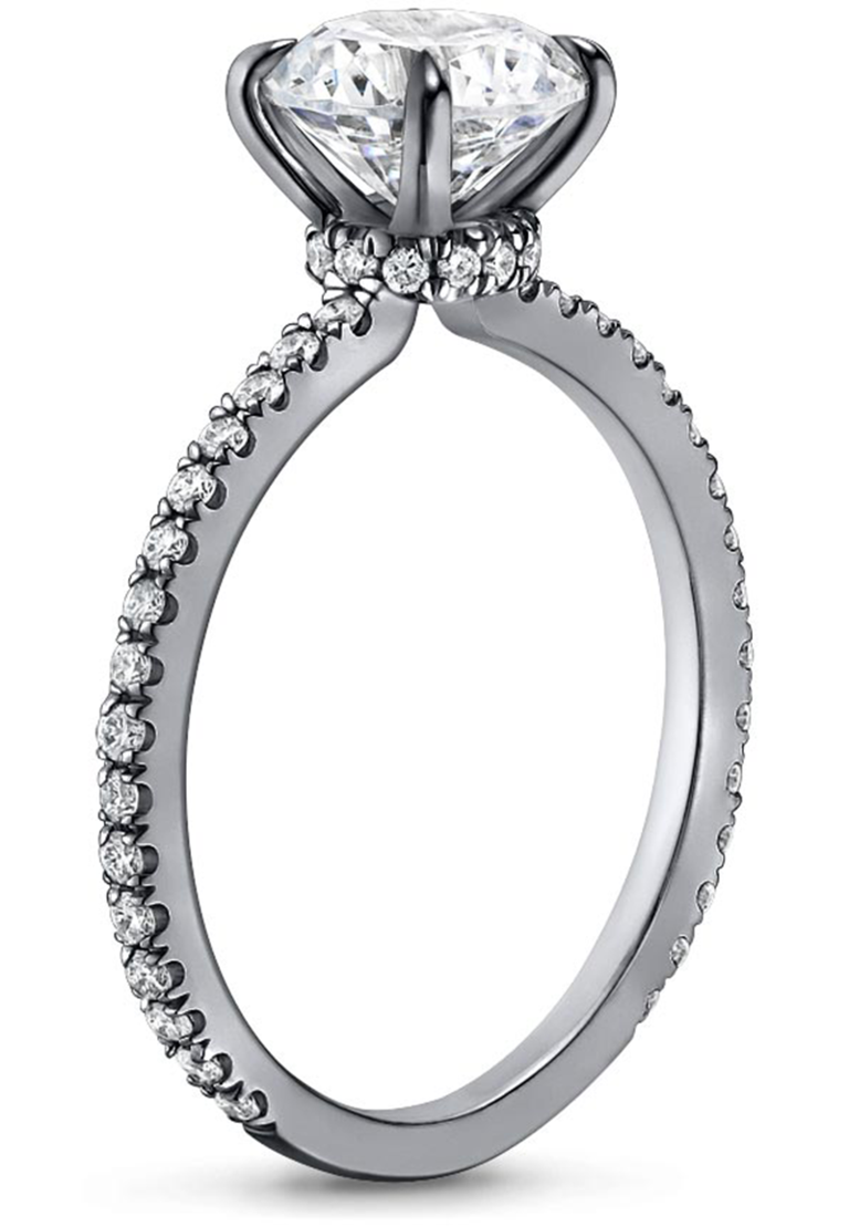Oval center diamond with hidden halo and prongs on thin black rhodium band with pave diamonds