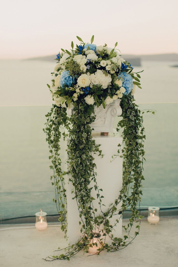 The couple chose white carnations and roses, cascading green ivy and blue hydrangeas to decorate the outdoor reception.